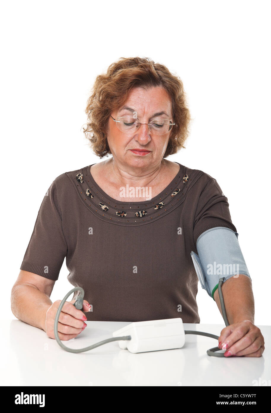 senior woman check her blodd pressure with machine Stock Photo