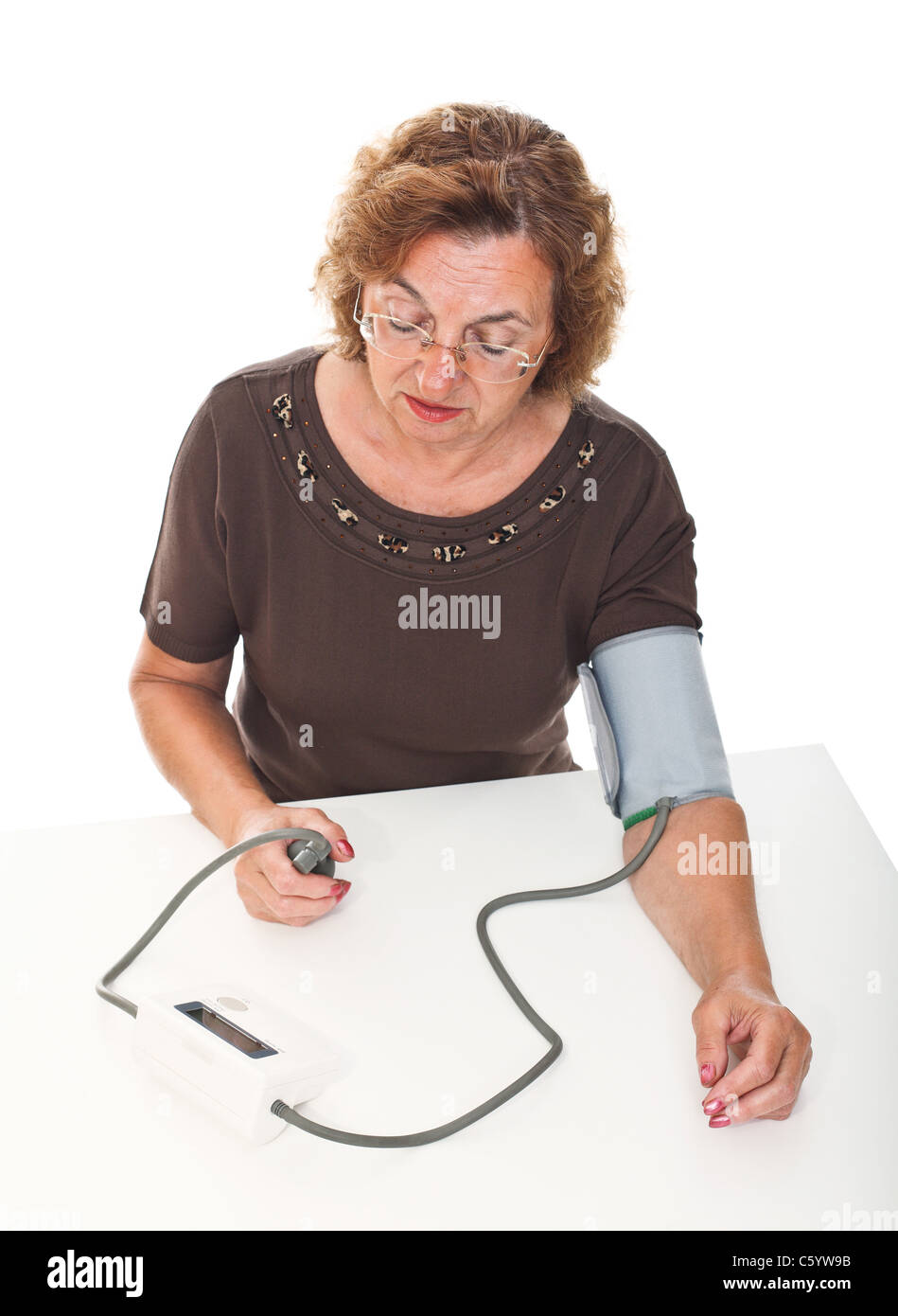senior woman check her blodd pressure with machine Stock Photo