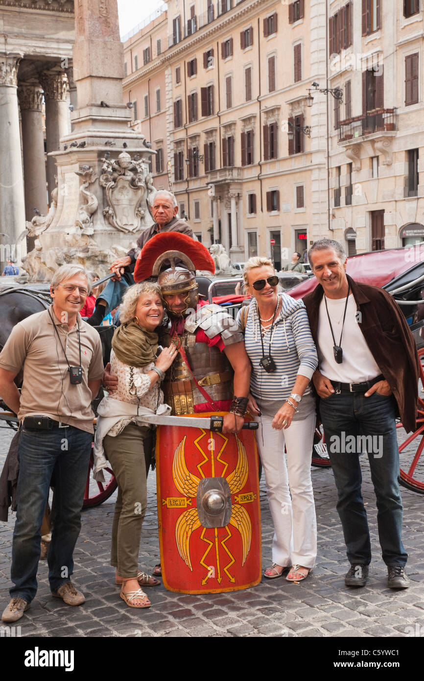 Italy, Rome, Tourists Posing with Man in Gladiator Costume Stock Photo