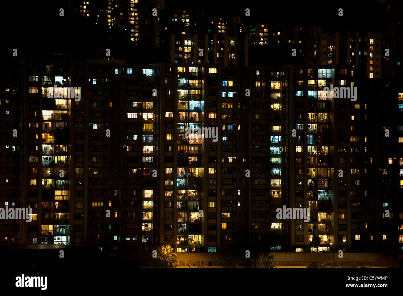 Hong Kong Modern Apartment Blocks at Night from Victoria Harbour Stock Photo