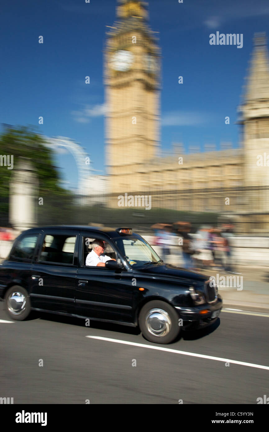 London taxi passing Houses of Parliament, London Stock Photo