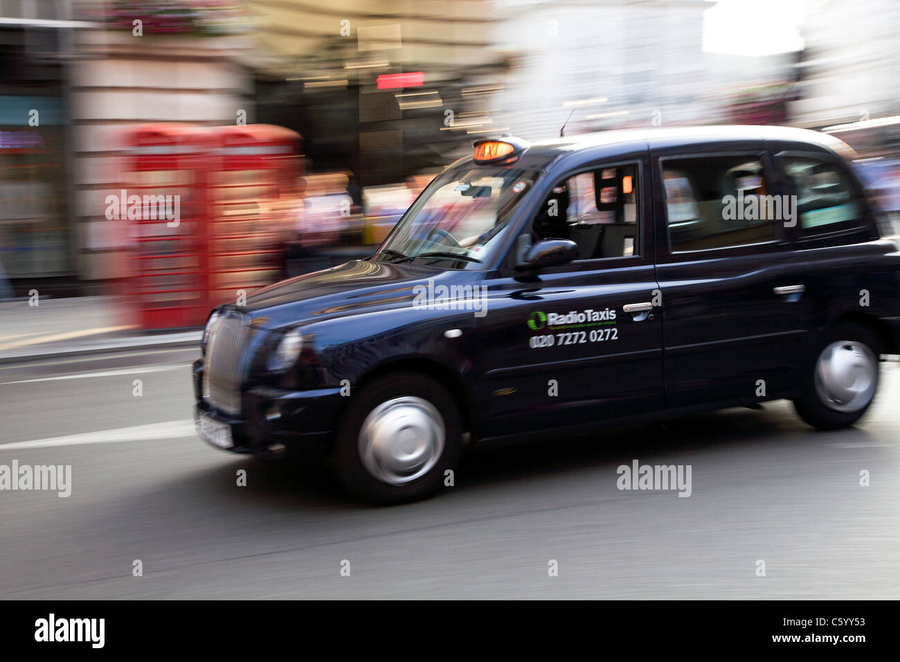 London taxi at speed in Haymarket Stock Photo