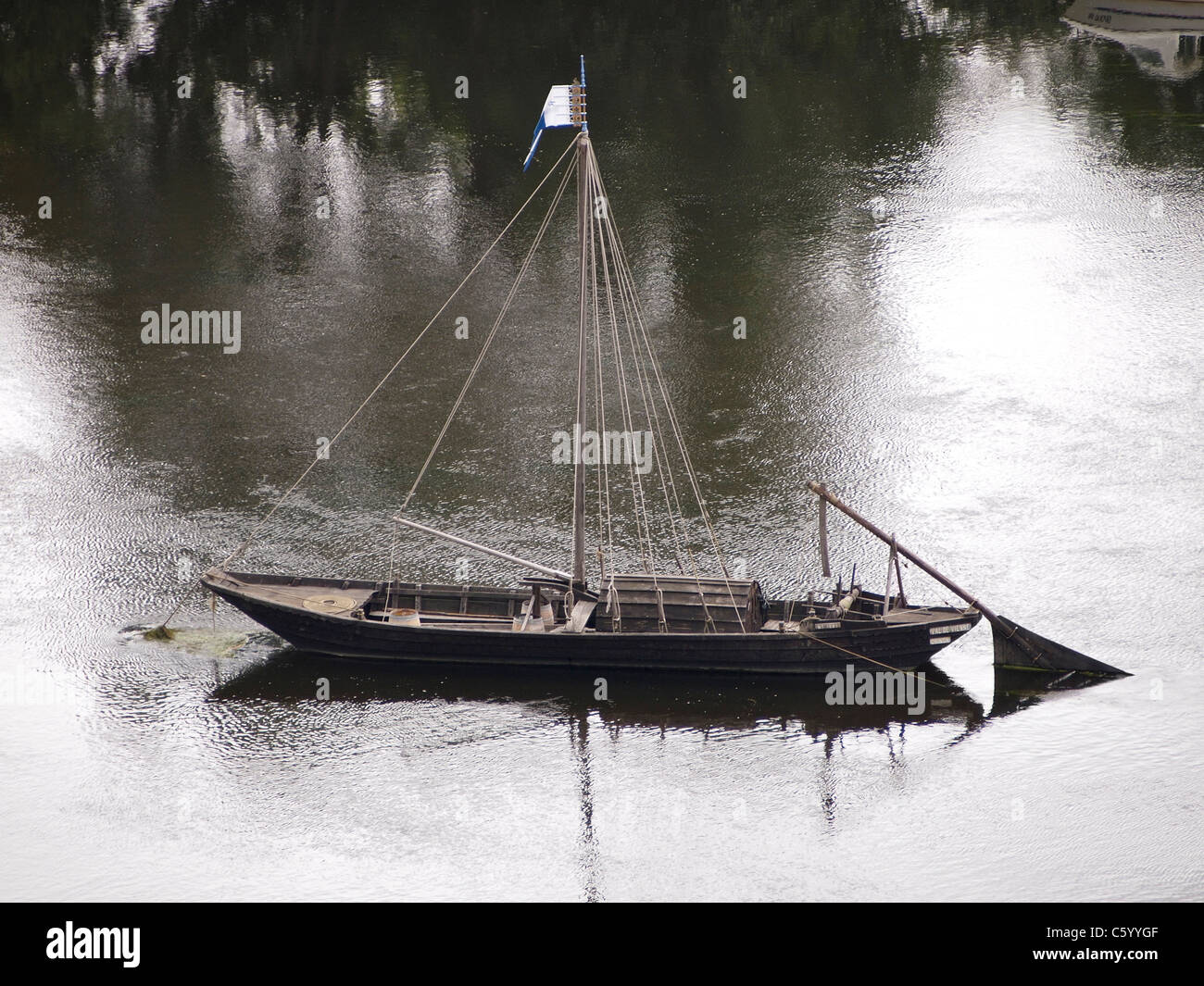 Typical traditional wooden Loire boat anchored in the river near Chinon, Loire valley, France Stock Photo