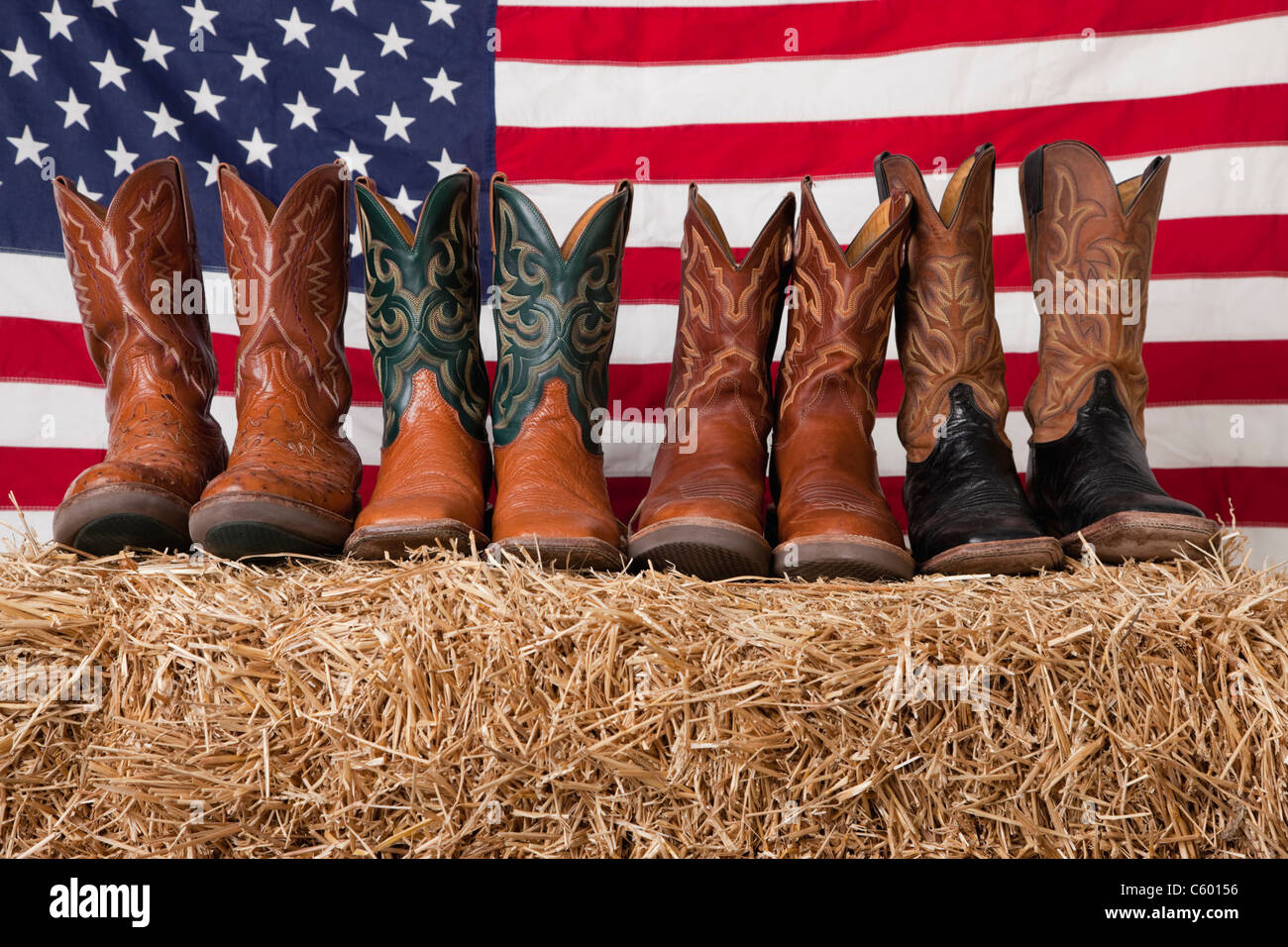 USA, Illinois, Metamora, Row of cowboy boots on haystack with American flag  on background Stock Photo - Alamy