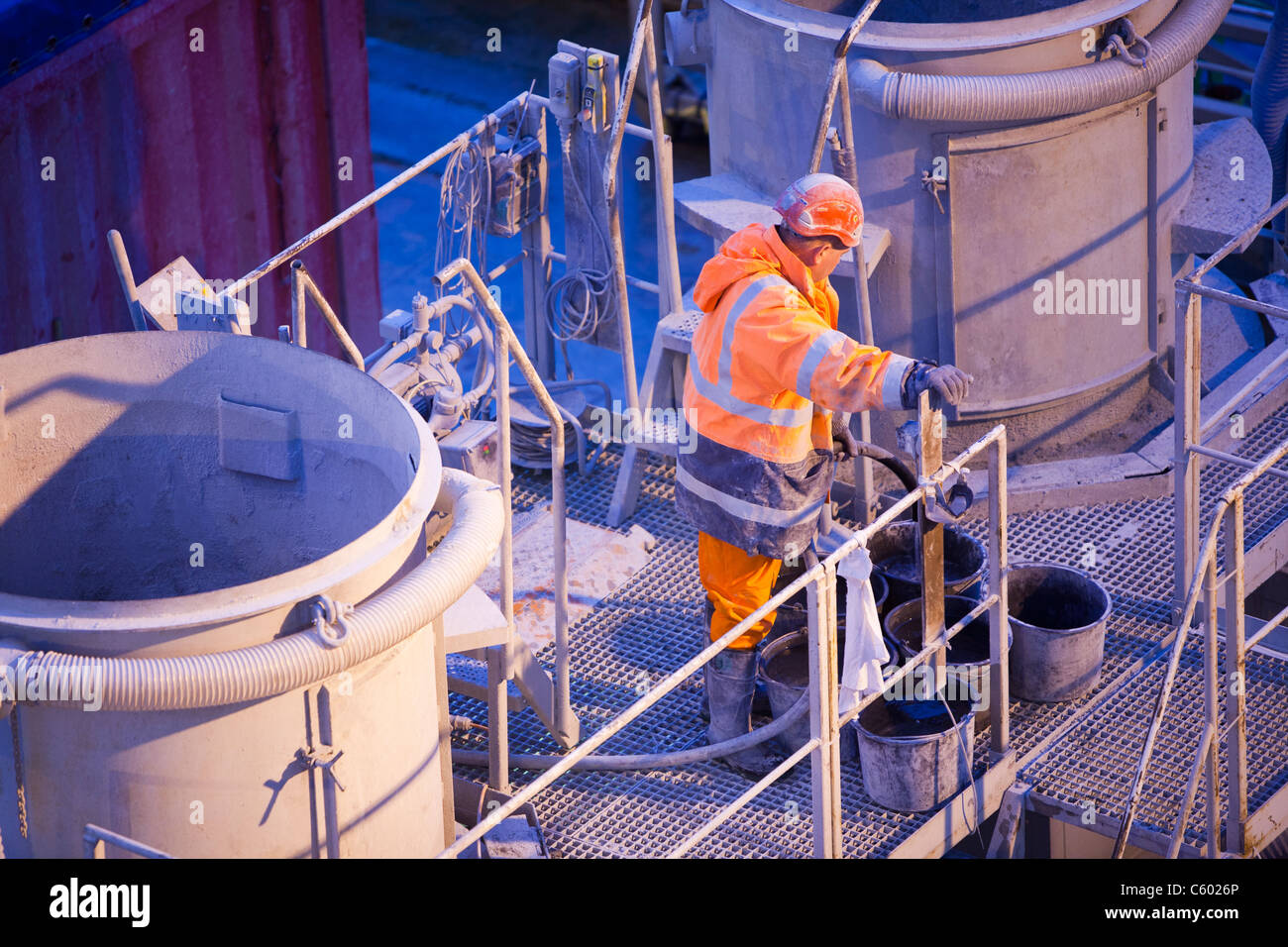Mixing specialist grout to fix pieces of wind turbine into place on the Walney offshore wind farm, UK. Stock Photo