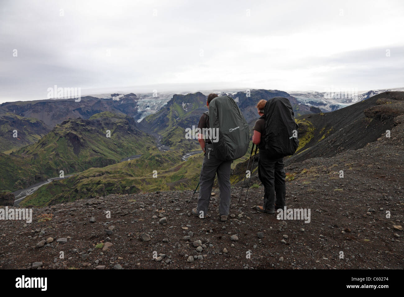 2 Hikers and View from Kattarhryggir Ridge, Gooaland Looking Towards the Katla Volcano Covered by Myrdalsjokull Glacier, Iceland Stock Photo