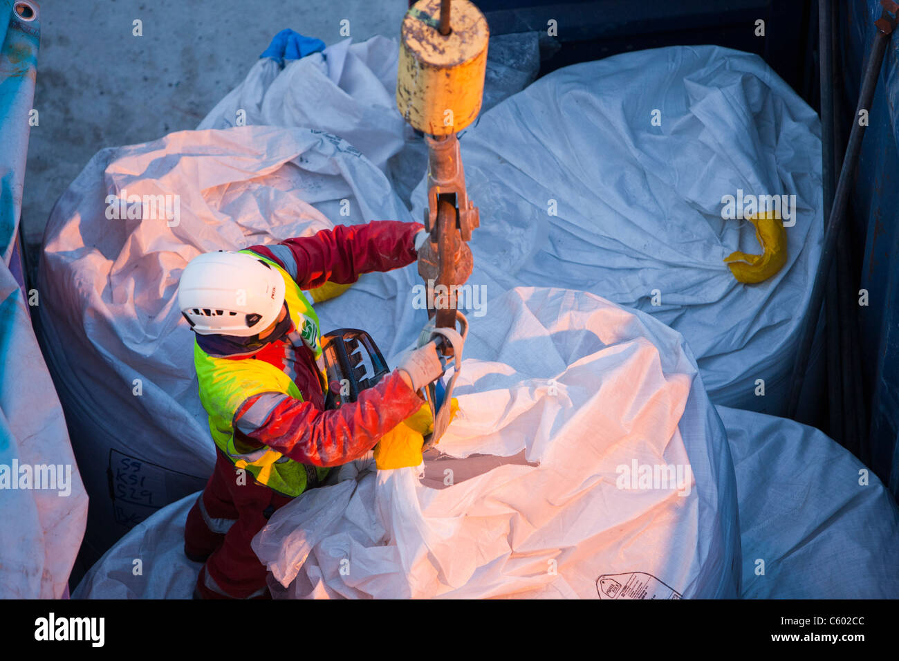 lifting bags of specialist grout to fix wind turbine pieces into place
