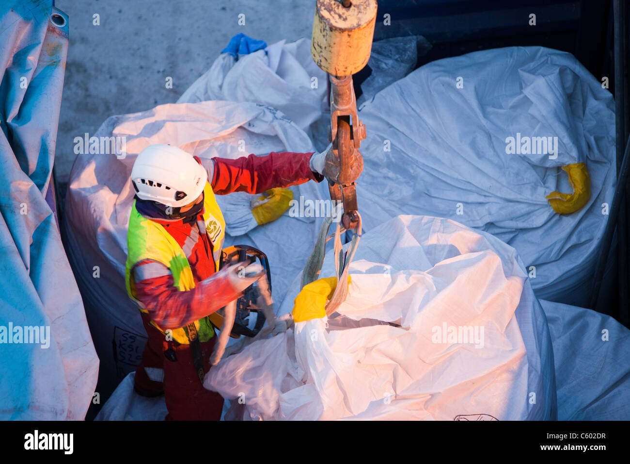 lifting bags of specialist grout to fix wind turbine pieces into place