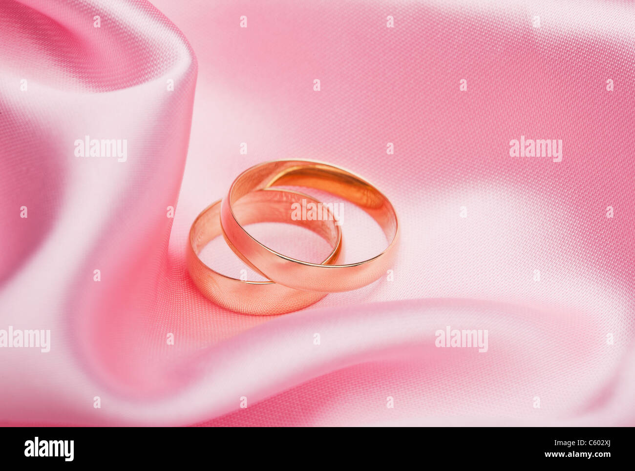 USA, Illinois, Metamora, Two wedding bands on pink silk Stock Photo