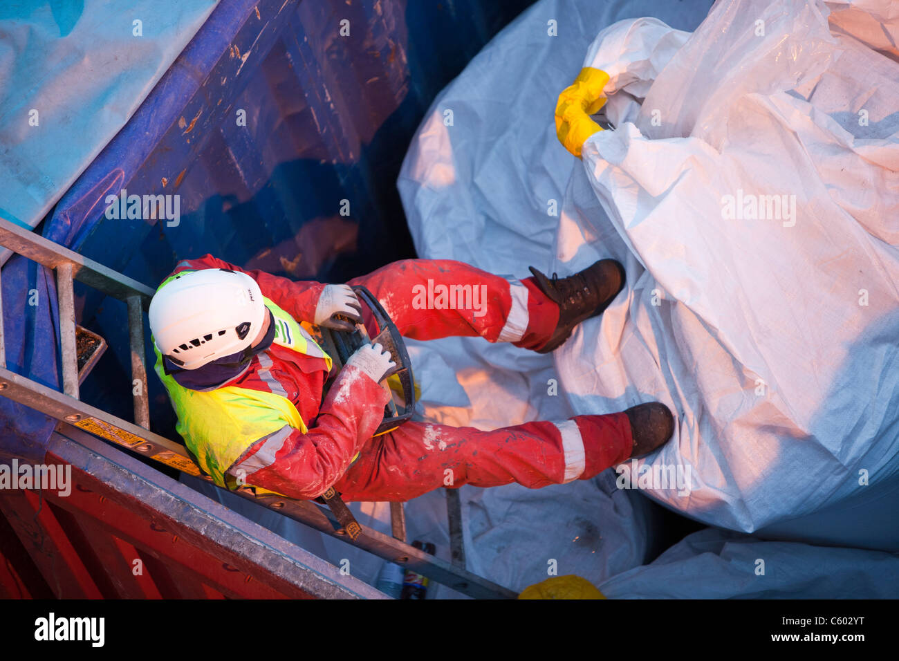 lifting bags of specialist grout to fix wind turbine pieces into place