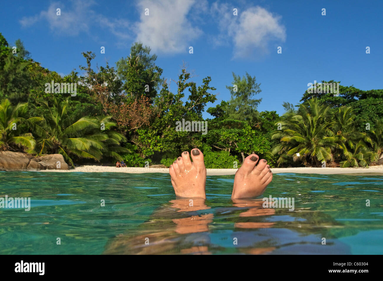 Womens Feet , Spit Level, Anse Lazio, Baie Sainte Anne district, Island of Praslin, Seychelles, Indian Ocean, Africa Stock Photo