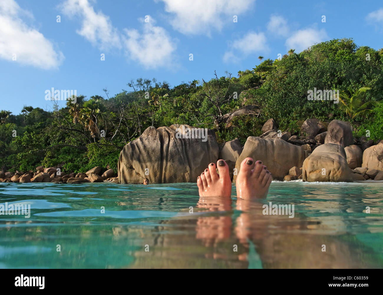 Womens feet, split level, Anse Lazio, Baie Sainte Anne district, Island of Praslin, Seychelles, Indian Ocean, Africa Stock Photo