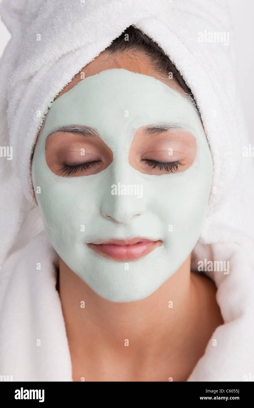 Young woman having facial mask Stock Photo