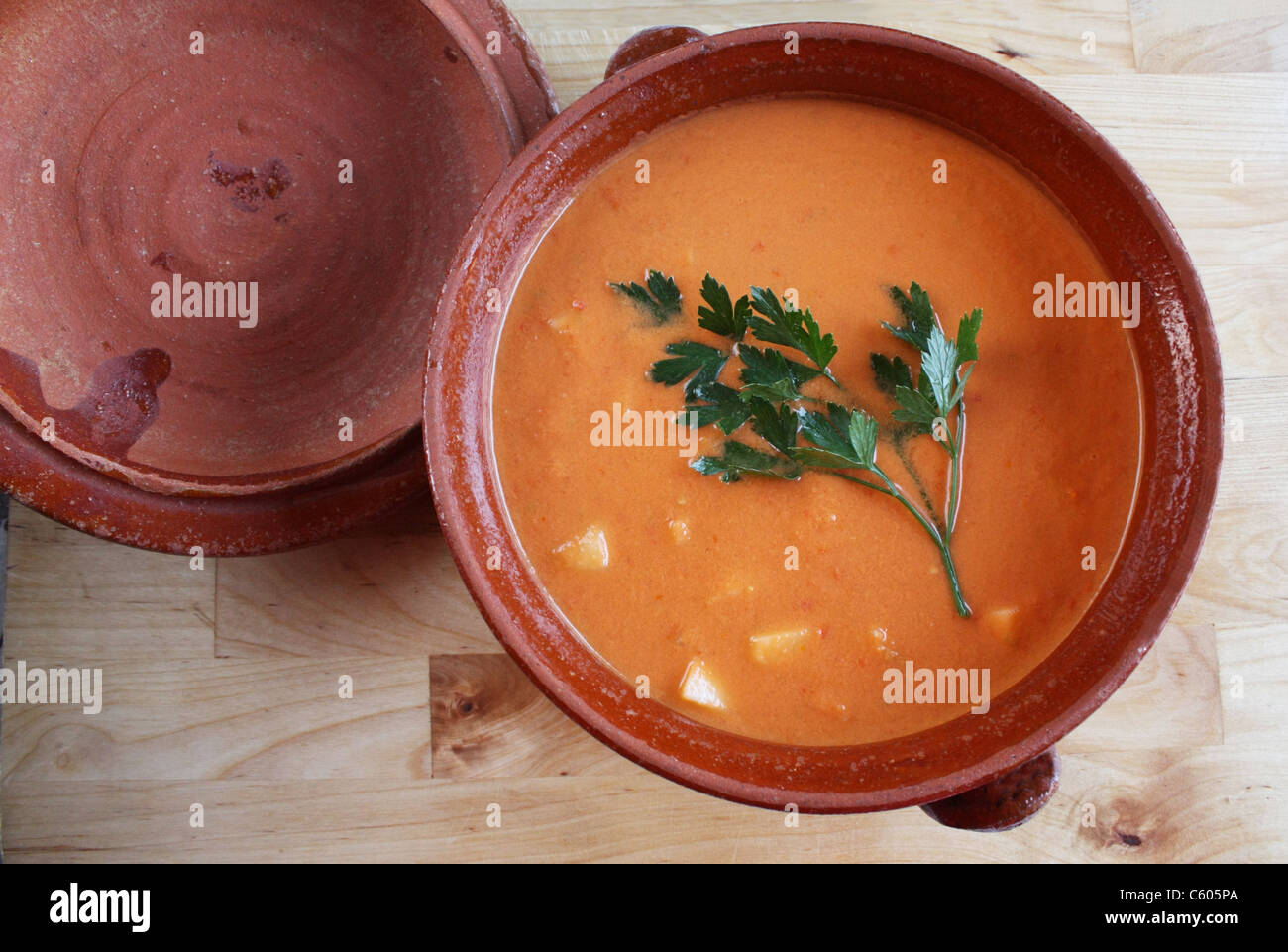 Closeup of a gazpacho andaluz (Andalusian cold soup) on a wooden kitchen board. Stock Photo