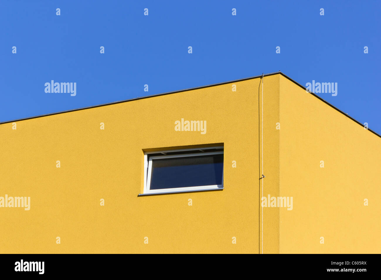 yellow building detail under blue sky Stock Photo