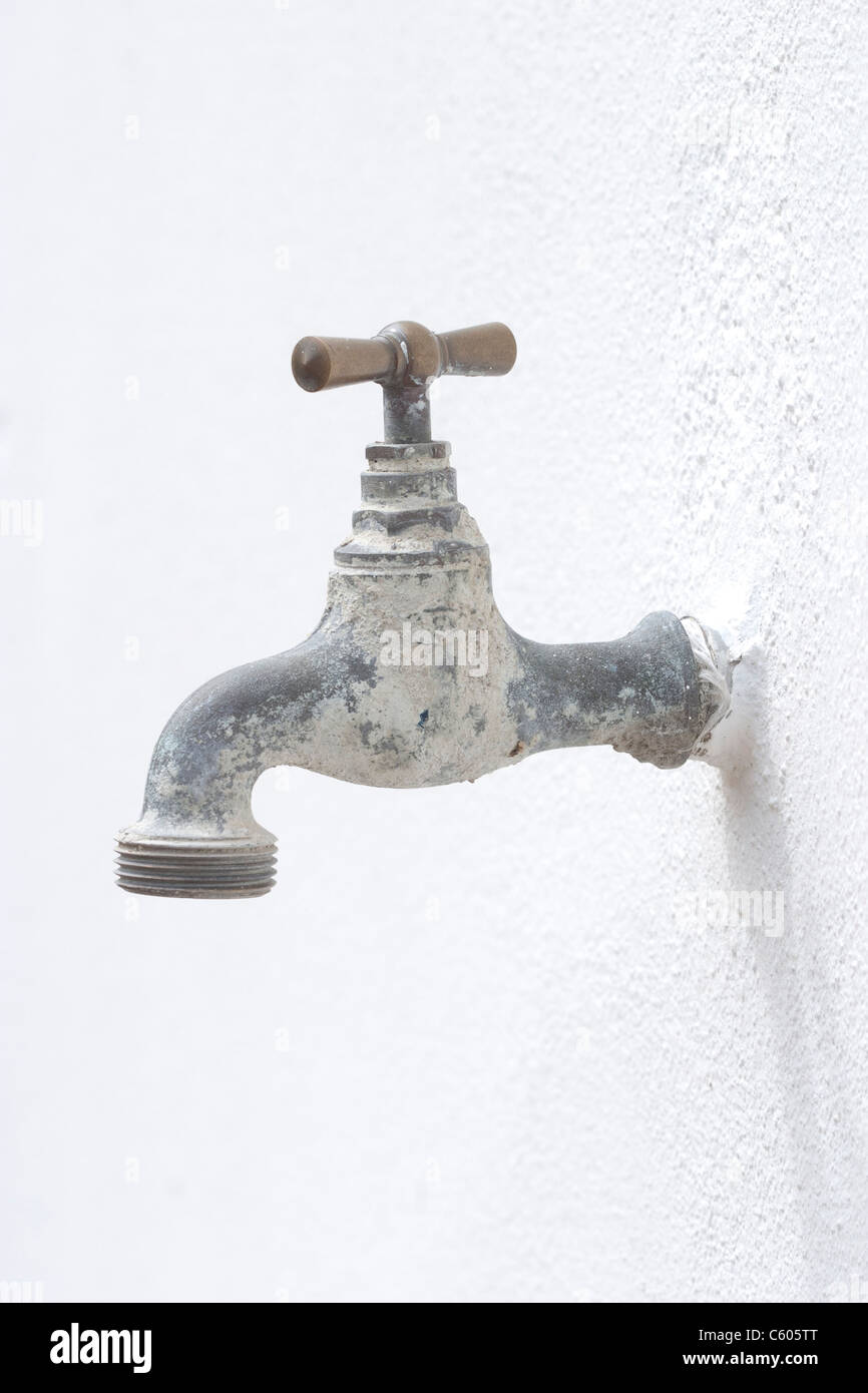 Old water tap on a wall Stock Photo