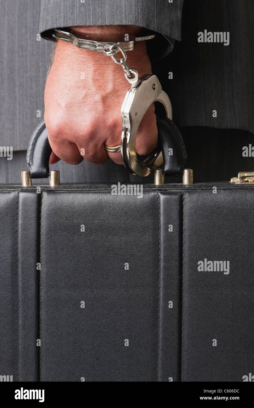 Businessman handcuffed to briefcase Stock Photo Alamy