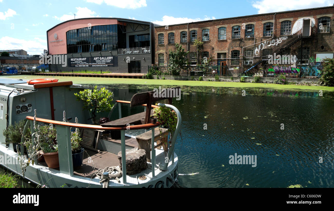 Lea Navigation River canal houseboat and Forman's Restaurant and Art Gallery Lea Valley East London UK  KATHY DEWITT Stock Photo