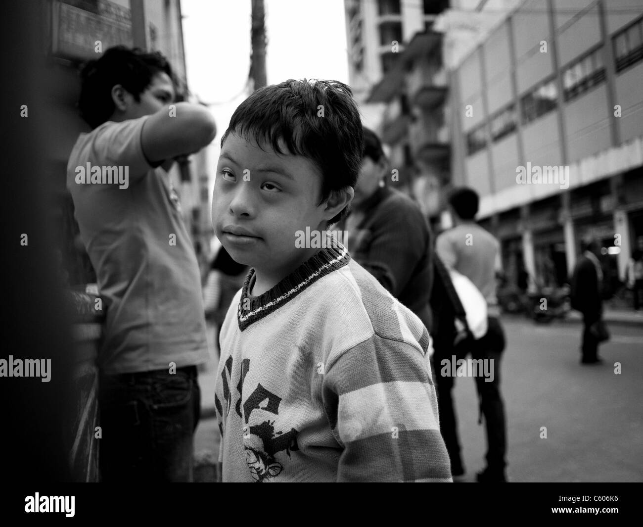 Street portrait of a young boy with down syndrome. Stock Photo