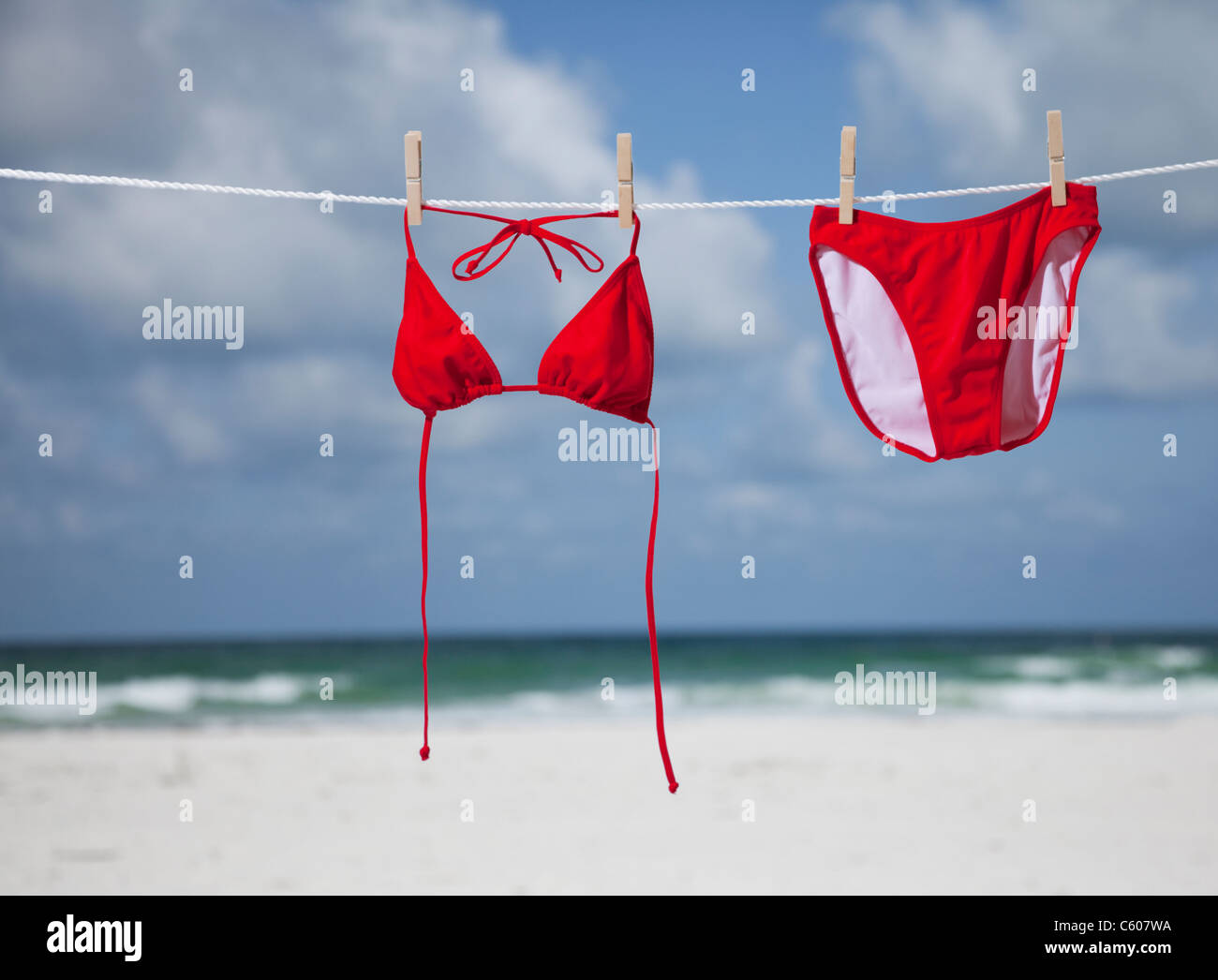 USA, Florida, St. Pete Beach, Red bikini hanging on clothesline on beach Stock Photo