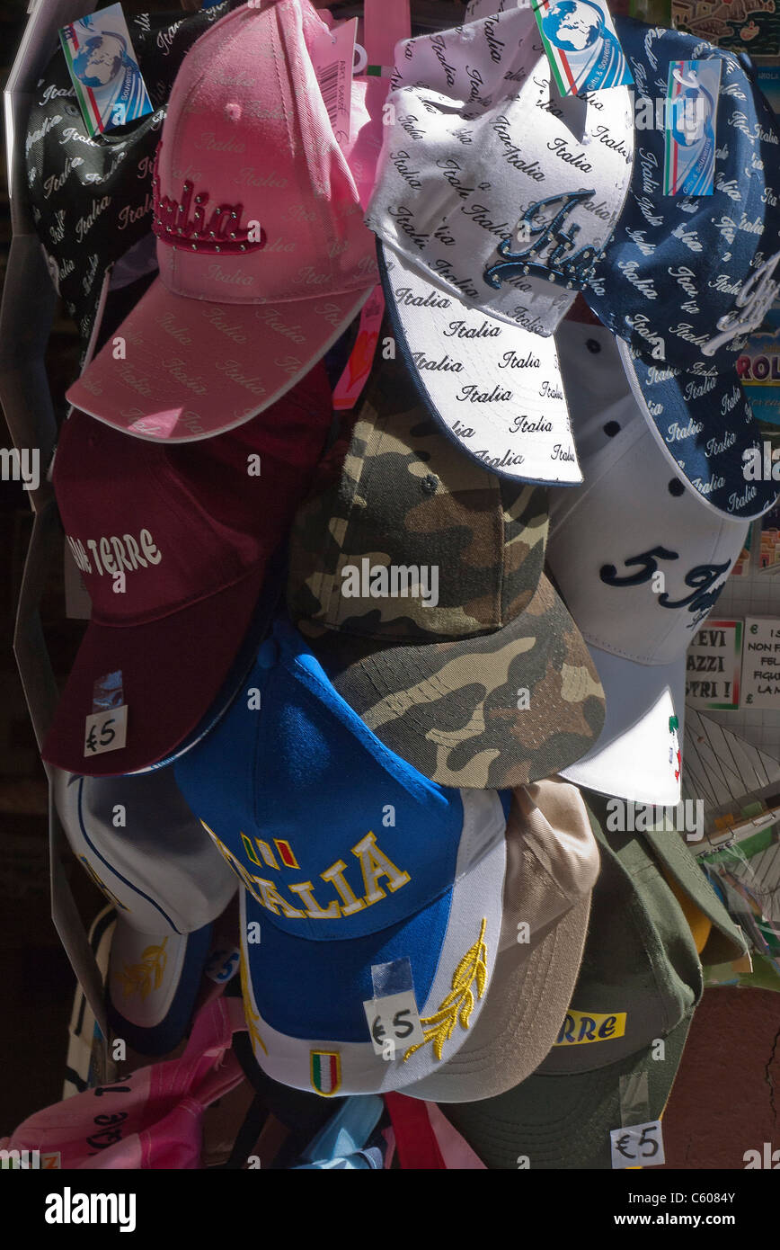 Italian designer baseball hats with 'Italia' on them hang for sale outside the Central Market in Vernazza, Cinque Terre, Italy. Stock Photo