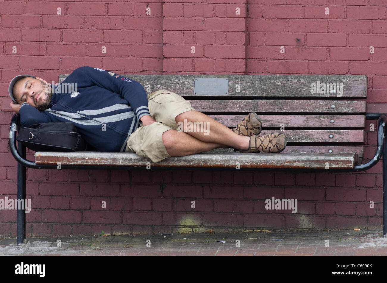 man asleep on a bench in Clapham, London Stock Photo - Alamy