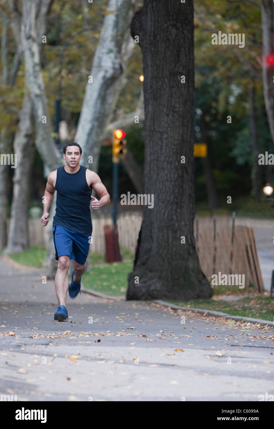 USA, New York, New York City, Young man jogging in park Stock Photo