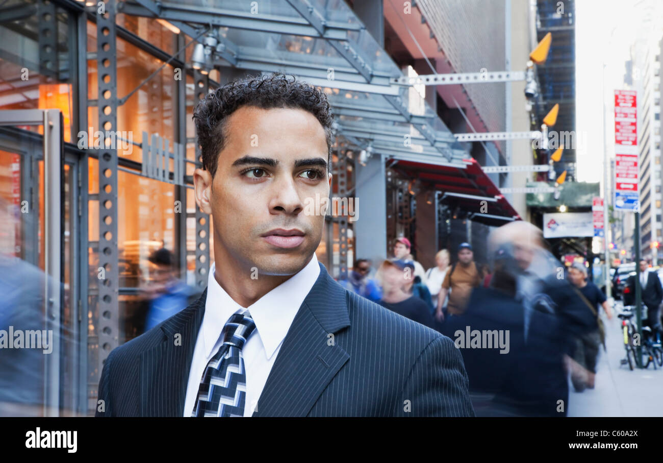USA, New York, New York City, portrait of smiling businessman on street Stock Photo