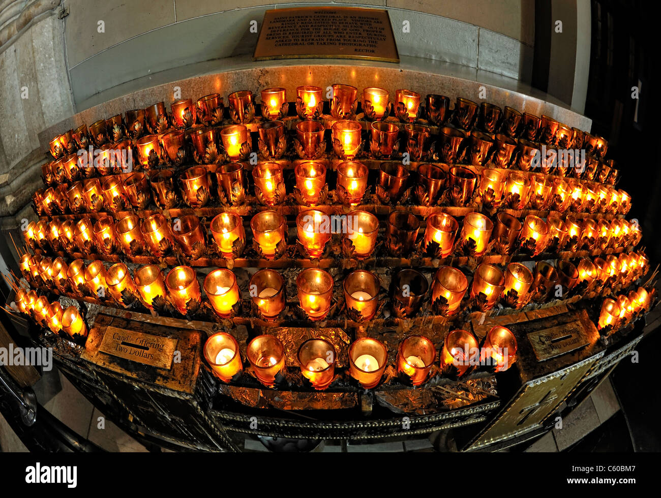 Votive candles inside St. Patrick's Cathedral, rows of lit Offering