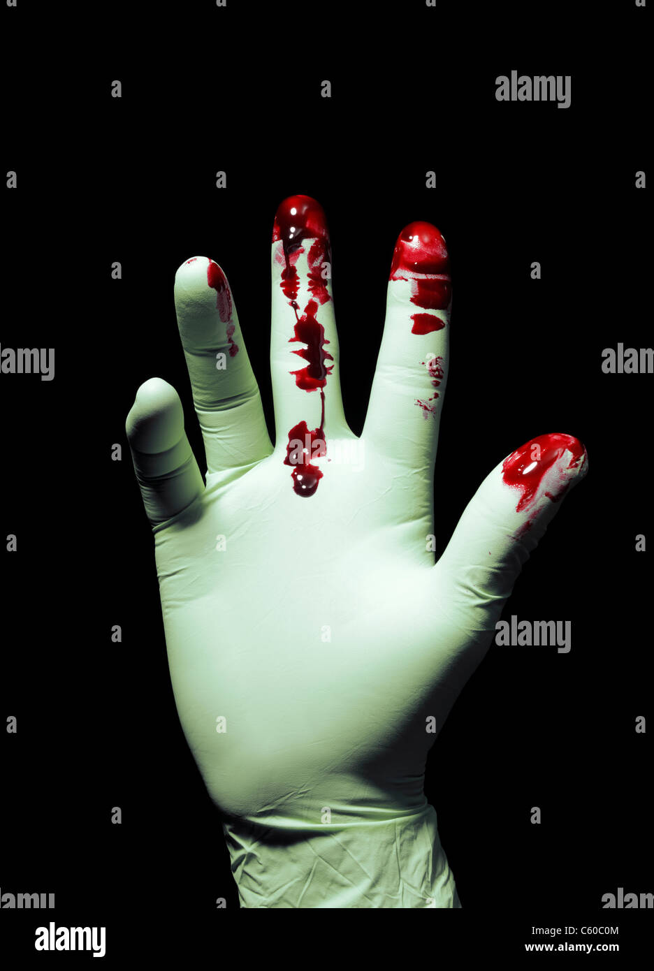 Hand wearing Bloody Surgical gloves Stock Photo