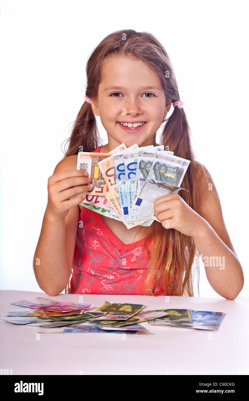 eight year old girl counts her money Stock Photo