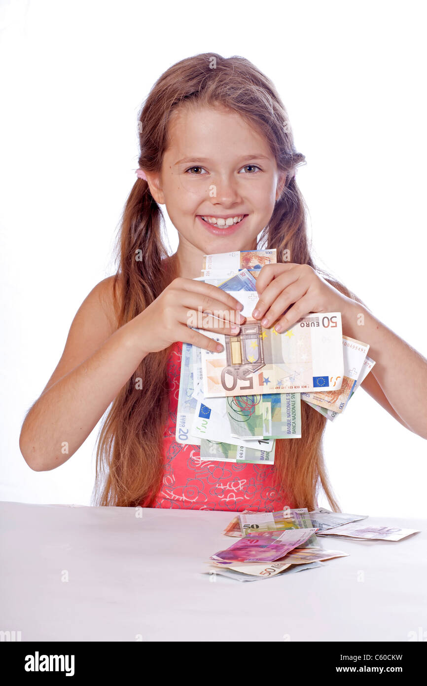 eight year old girl counts her money Stock Photo