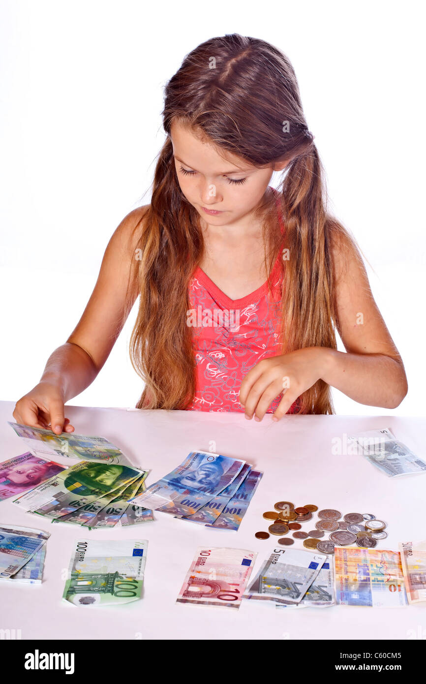 eight year old girl counts her money Stock Photo