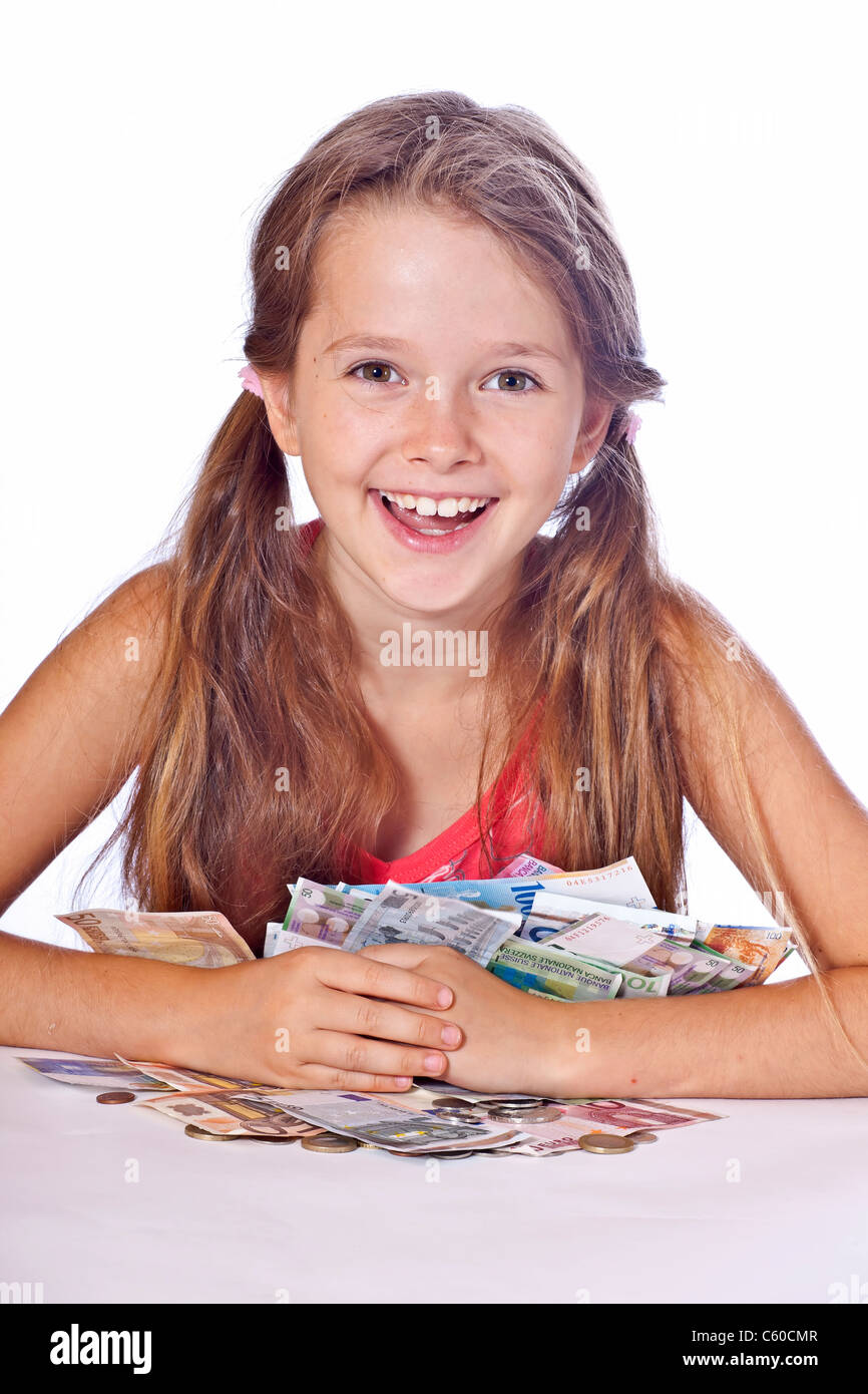 eight year old girl counts her money Stock Photo