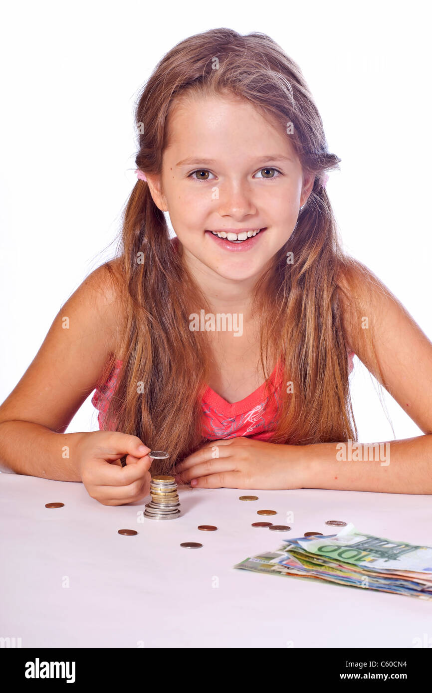 eight year old girl counts her money Stock Photo