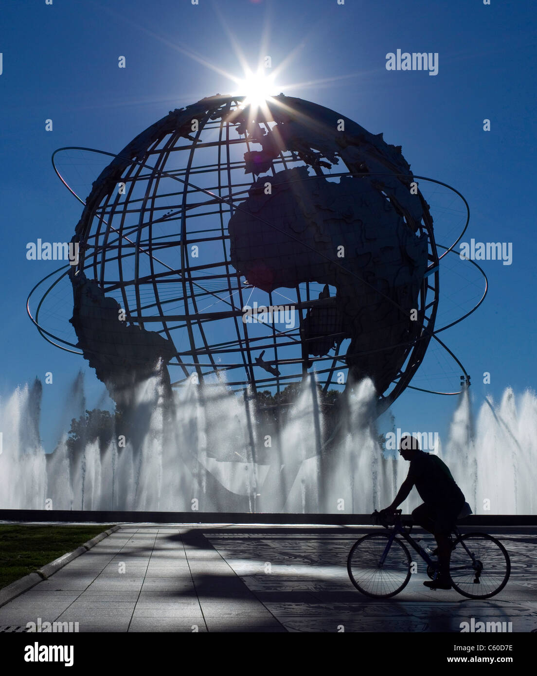 A man cycles near the Unisphere in Flushing Meadows Corona Park in the borough of Queens Tuesday, Sept. 14, 2010, in New York. Stock Photo
