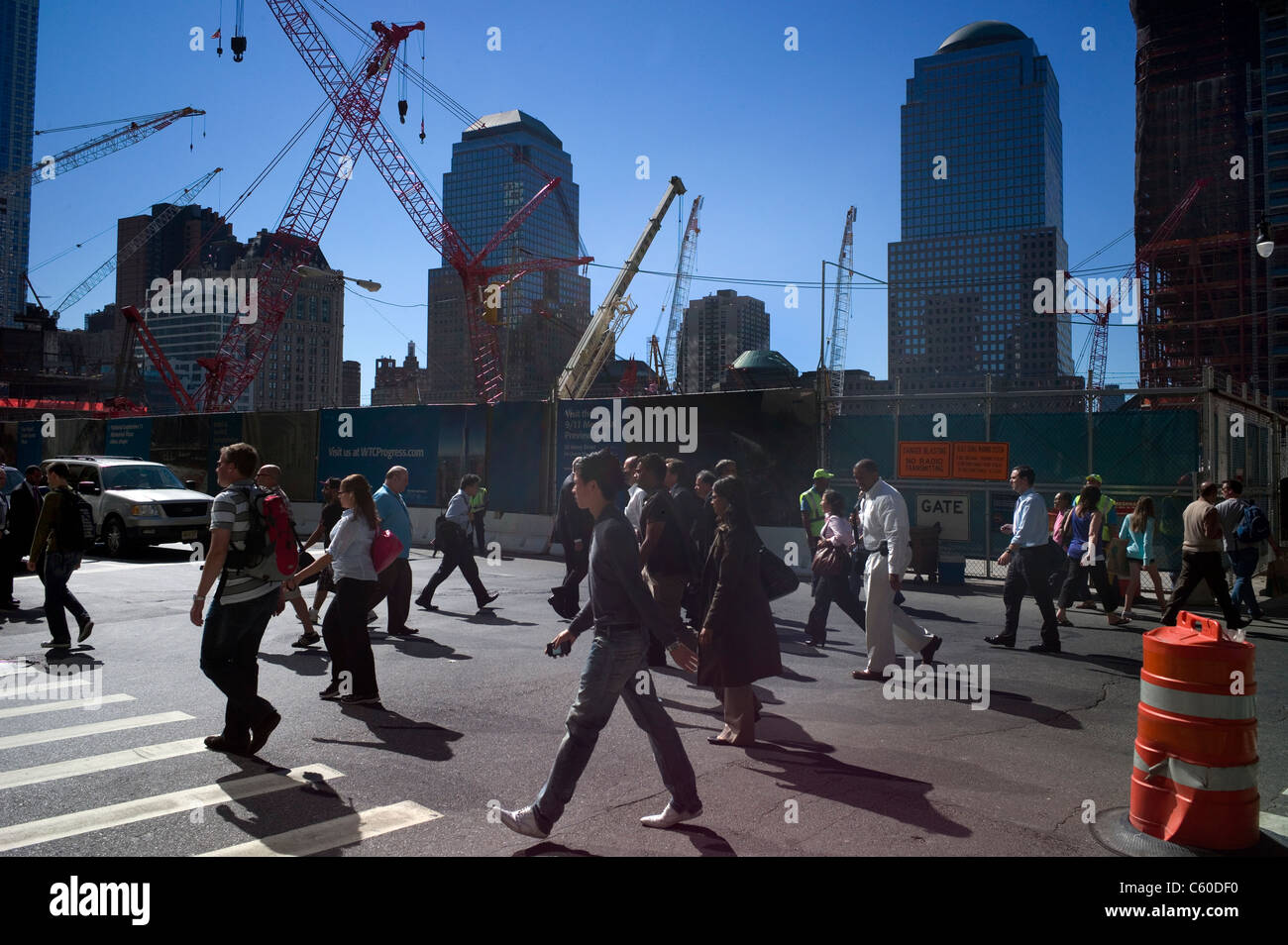 Pedestrians walk past ongoing construction at the ground zero World Trade Center site Wednesday, Sept. 15, 2010, in New York. Stock Photo