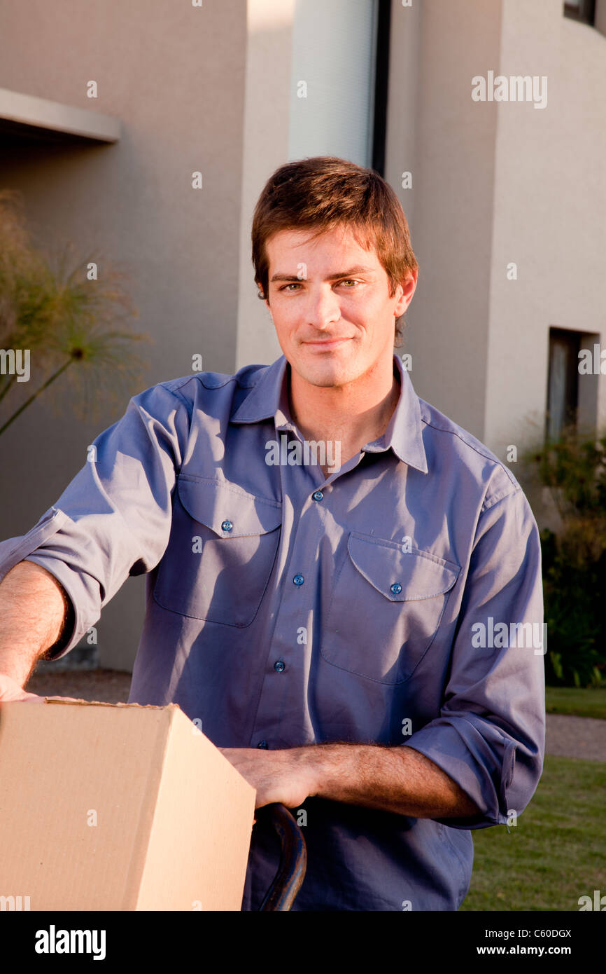 A portrait of a man with moving boxes on a trolly Stock Photo