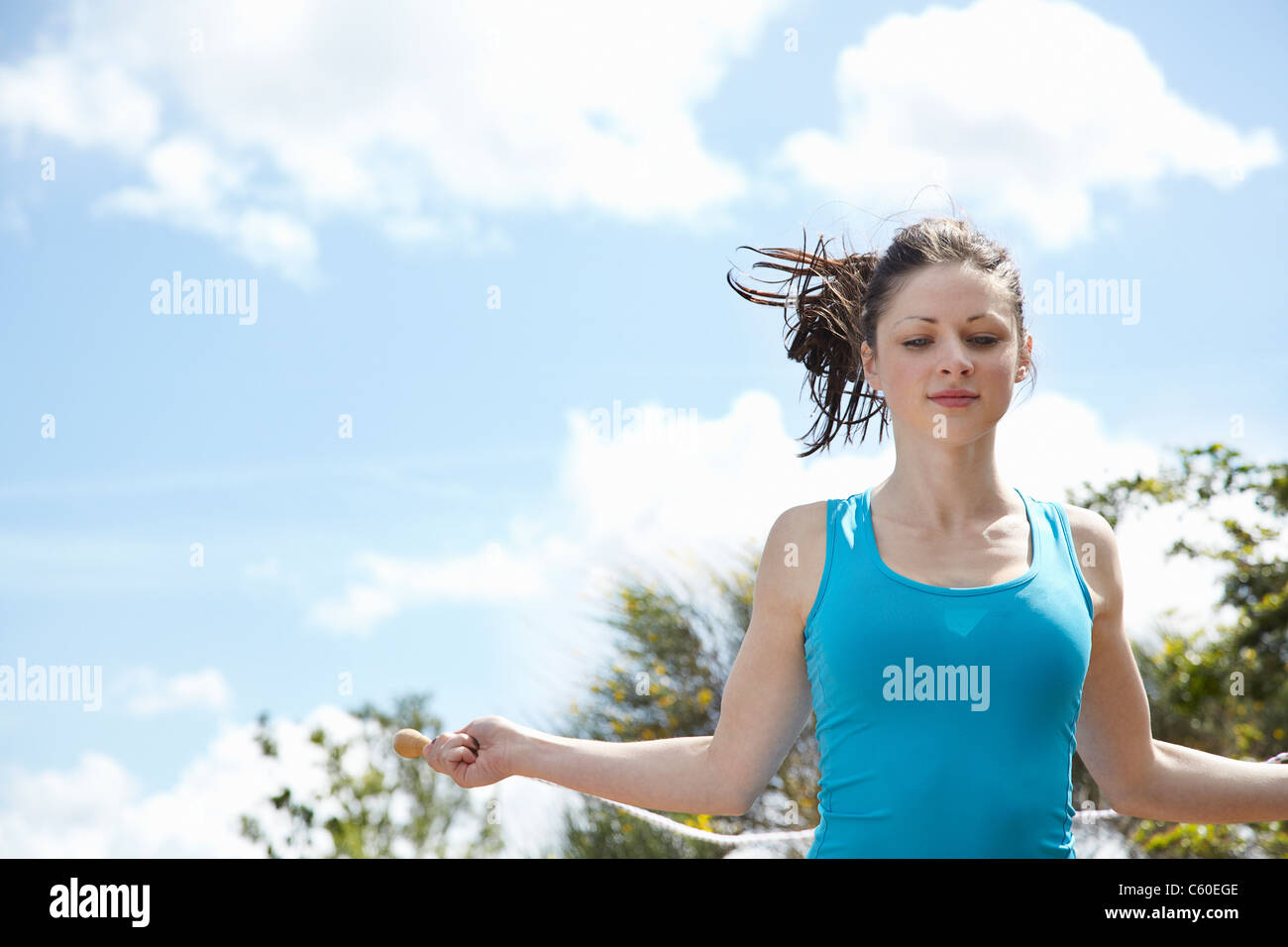 Woman jumping rope outdoors Stock Photo Alamy