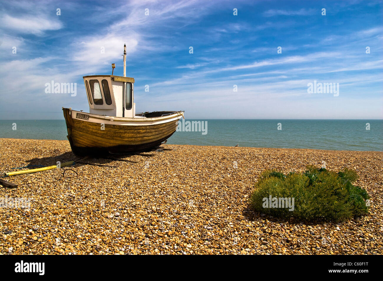 A single wooden fishing boat on a beach Stock Photo - Alamy