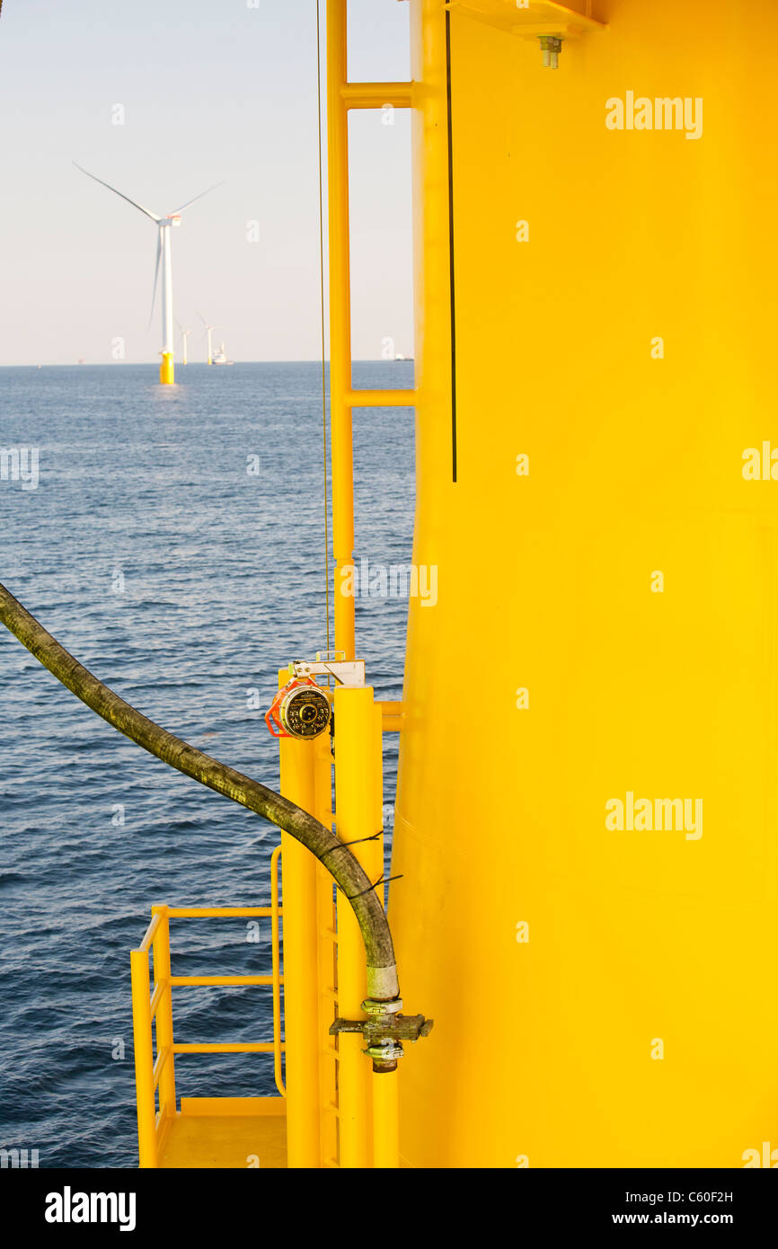 A pipe carries specialist grout to cement a transition piece to a monopile, on the Walney offshore wind farm. Stock Photo