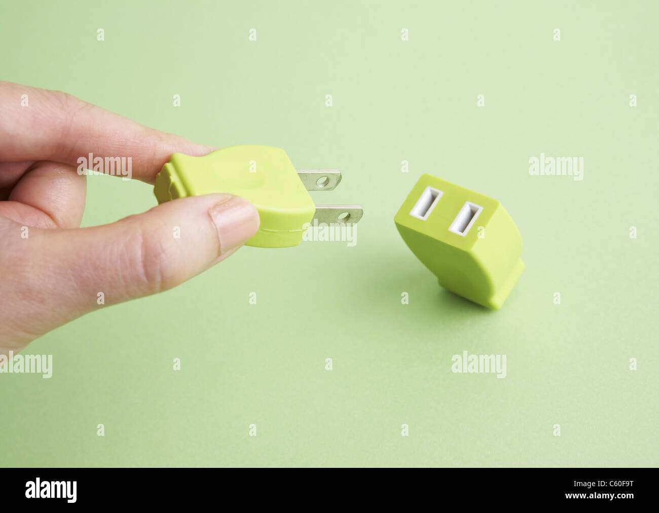 Hand holding plug and outlet Stock Photo - Alamy