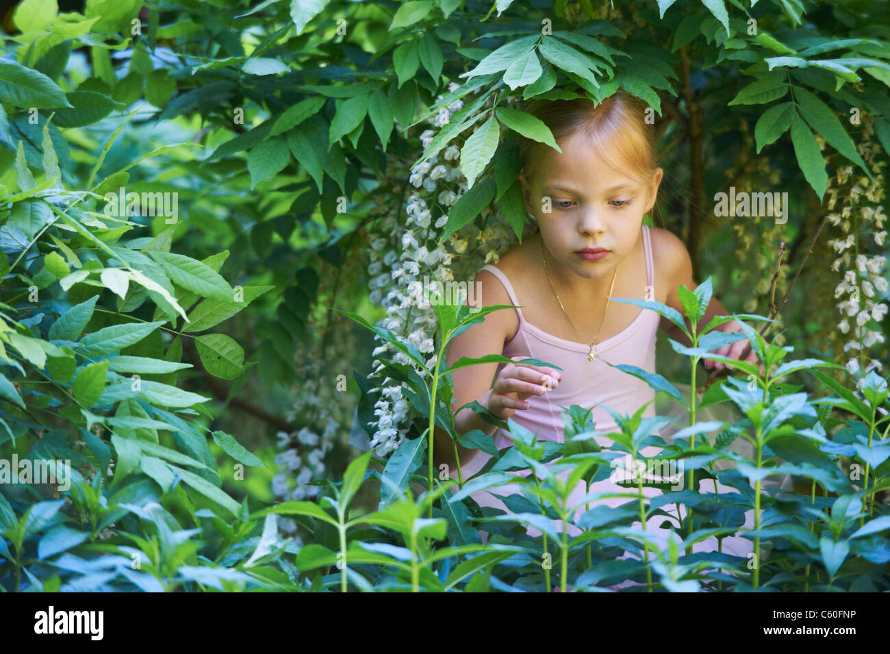 Girl in ballet costume playing in bush Stock Photo