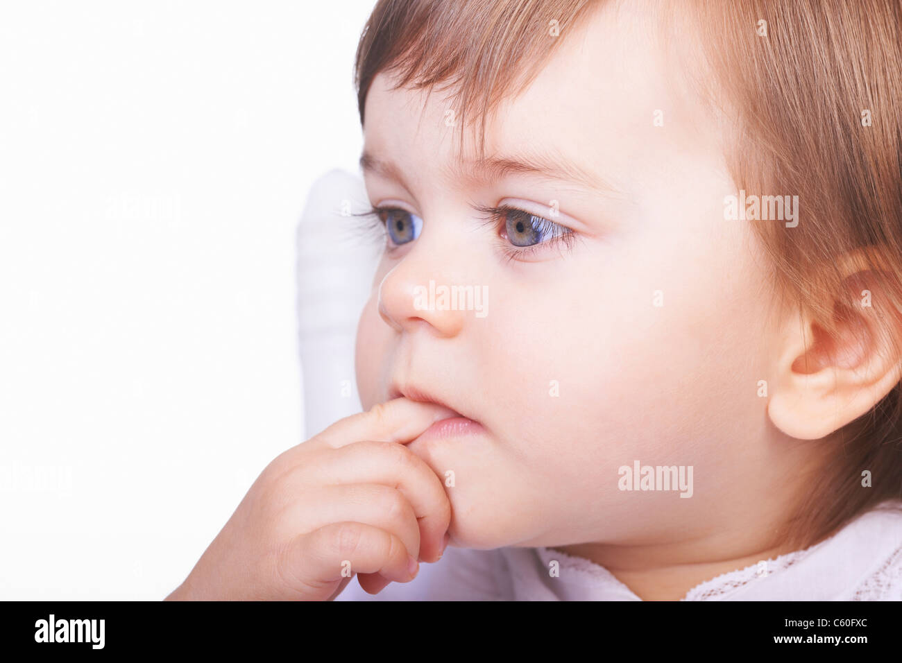 Baby girl chewing her finger Stock Photo Alamy