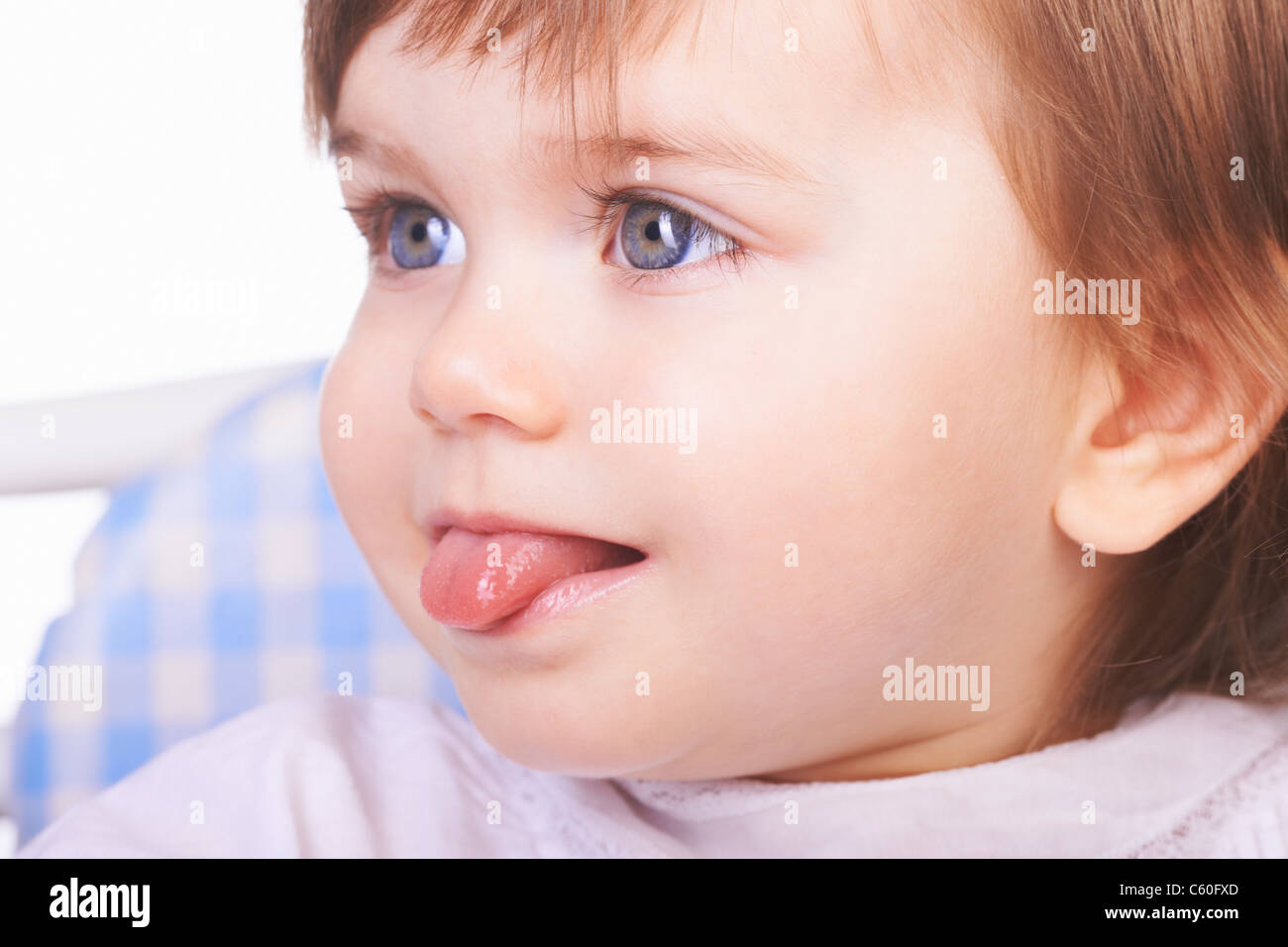 Baby girl sticking out her tongue Stock Photo - Alamy