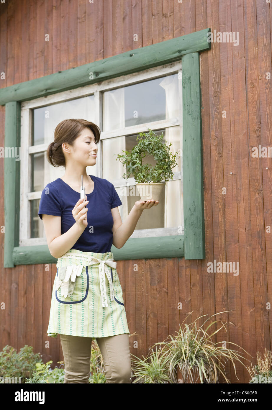 Woman holding potted plant Stock Photo - Alamy