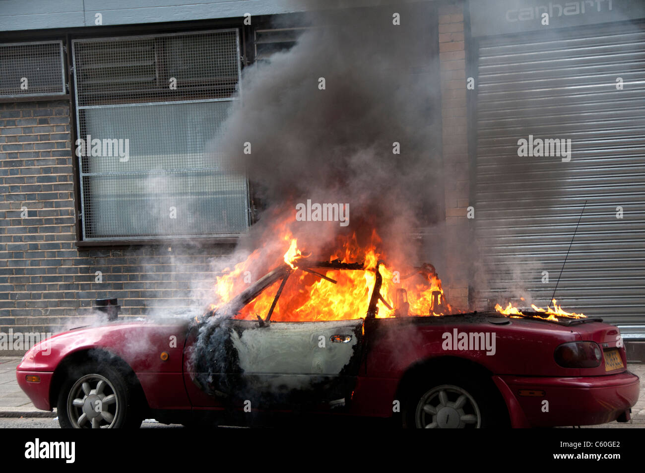 Burning car in front of Carhartt Warehouse which was looted during the riot  Stock Photo - Alamy