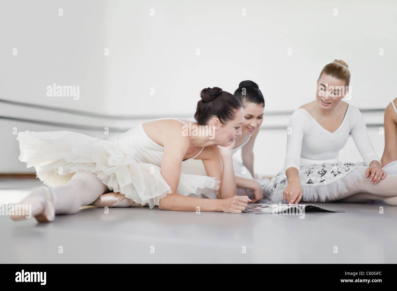 Ballet dancers reading magazine together Stock Photo