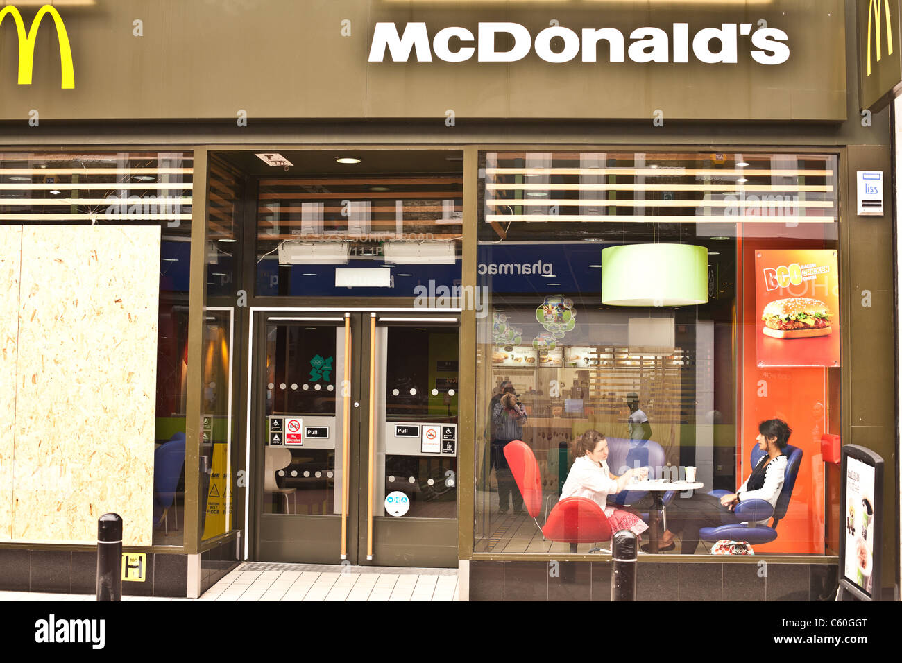 McDonald's shop boarded up after looting, arson and riots Stock Photo