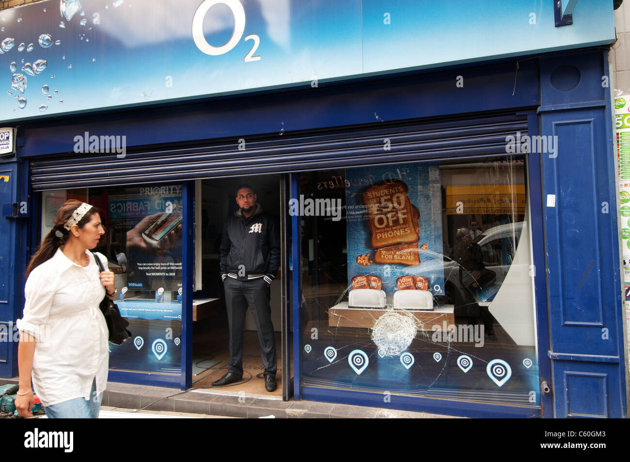 The Narrow Way. O2 mobile phone shop attacked last night , with passer by and shop worker in doorway Stock Photo